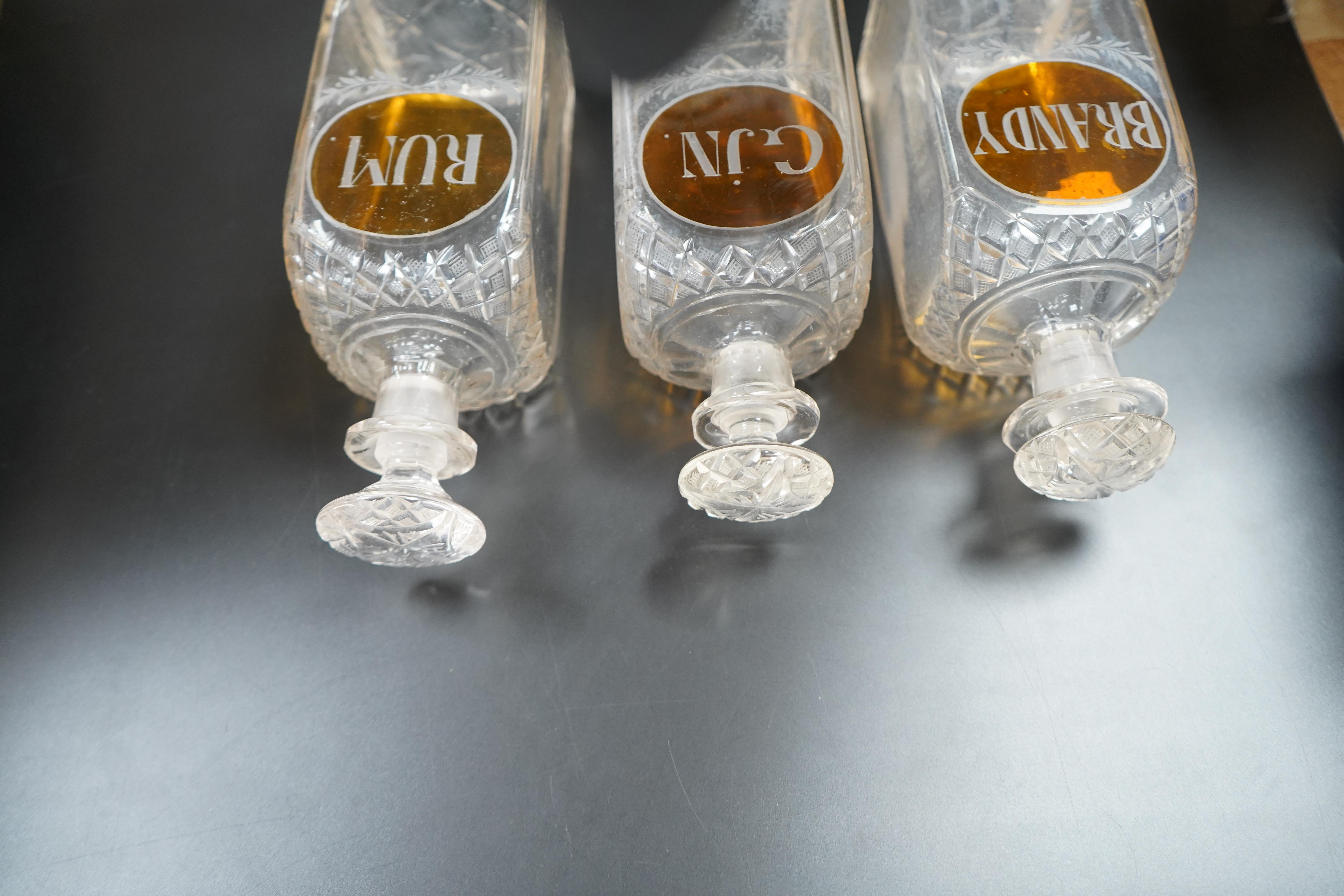 Three 19th century cut glass decanters for 'Rum' 'Gin' and 'Brandy', 23cm high